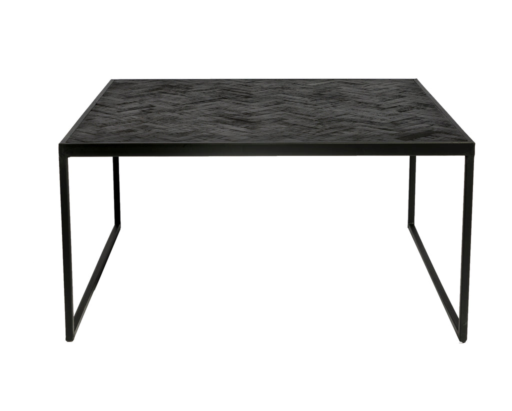 Zwart metalen tafel met minimalistisch ontwerp en subtiel zigzagpatroon op het tafelblad.