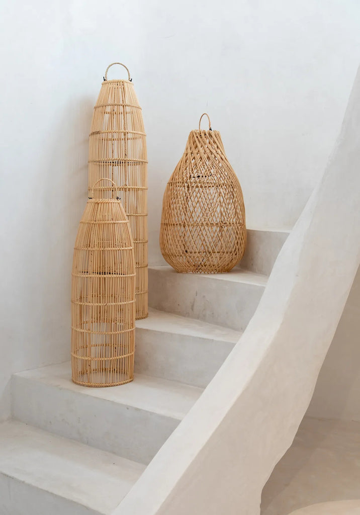 Drie rieten lampenkappen op witte stenen trappen, minimalistische inrichting in natuurlijke tinten.