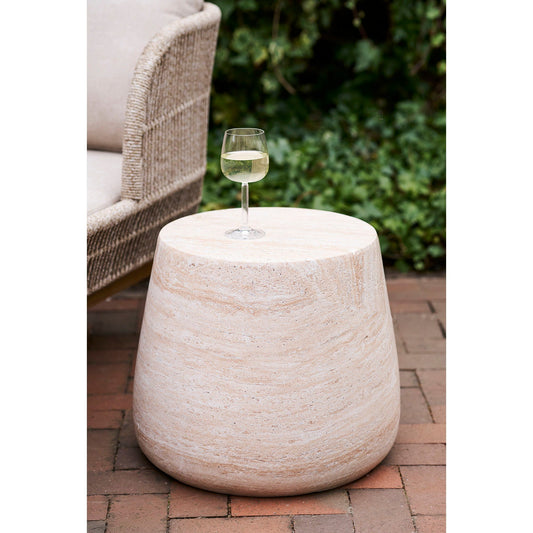 Detail van de ronde top van de Bonn bijzettafel van House Nordic in naturel fiberclay met glas witte wijn en steentextuur