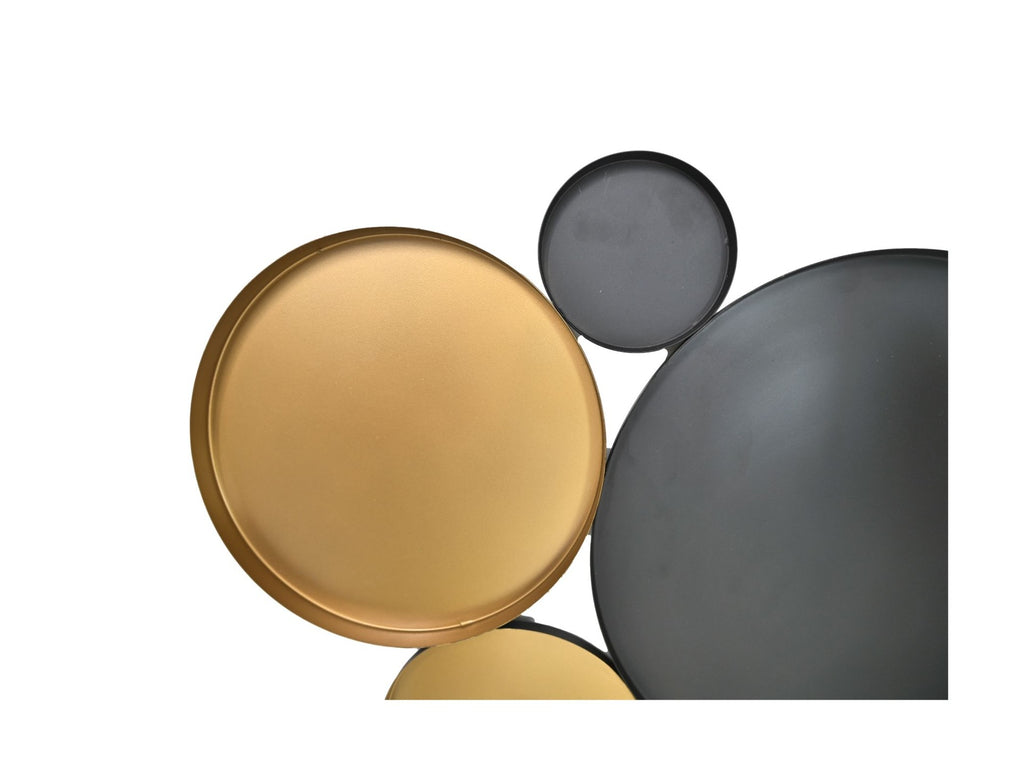 Gouden en zwarte metalen cirkels artistiek gerangschikt tegen een witte achtergrond.