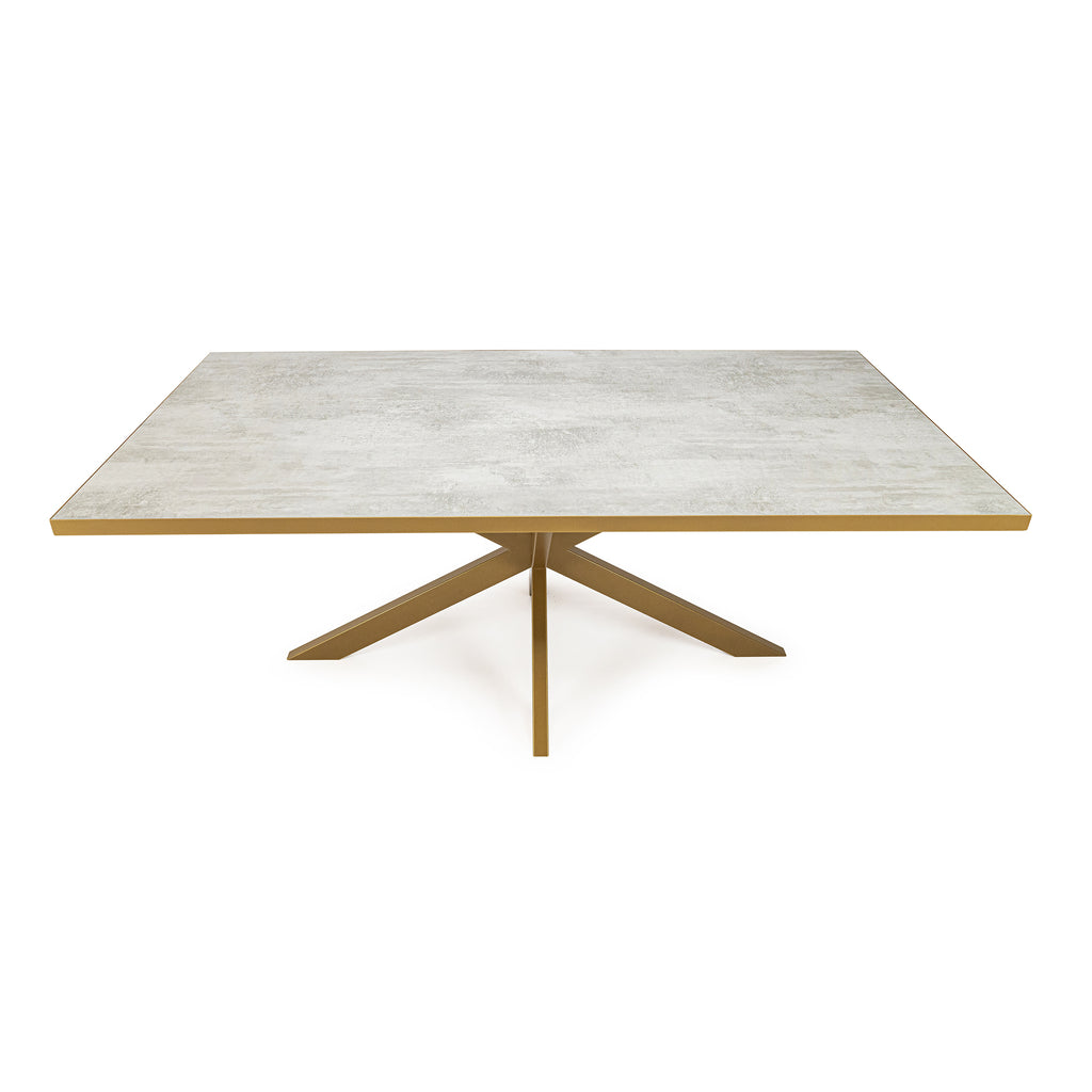 Rechthoekige tafel met grijs blad en gouden onderstel met vier poten in een stervorm.