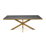 Stijlvolle eettafel met grijs marmeren blad en gouden metalen kruisvoet, modern en elegant design.