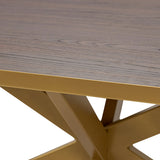 Zijaanzicht luxueuze eettafel Gijs met slank rechthoekig mat houtblad en robuust goudkleurig stalen kruisframe