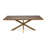 Moderne eettafel met een bronskleurig krasbestendig blad en kruisvormige metalen poten.